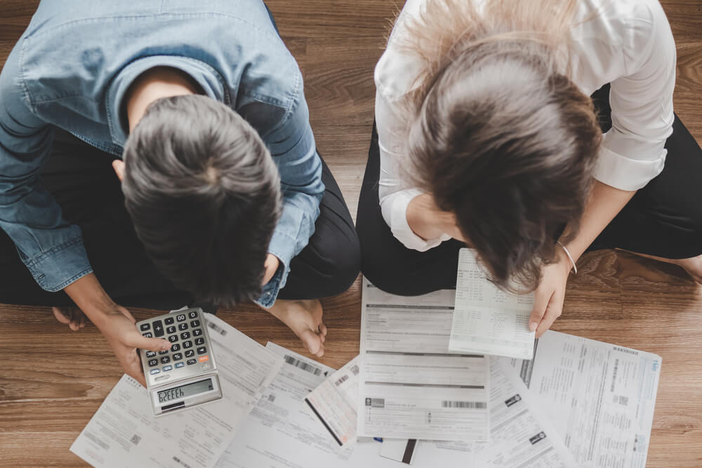 Top View Asian Couple Sitting on the Floor Stressed and Confused by Calculate Expense From Invoice or Bill