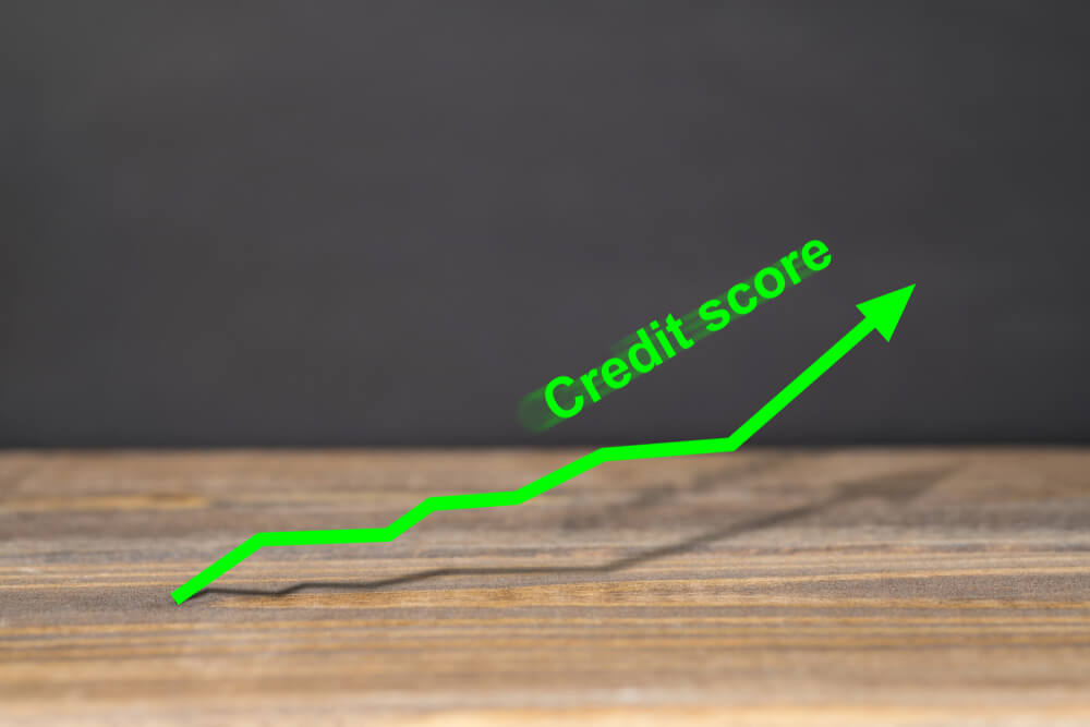 Green Upward Trend Graph Shows Excellent Credit Score on Wooden Surface With Black Background